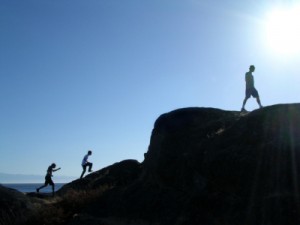 People Hiking a Boulder with Sun shinning- Aber Law Firm