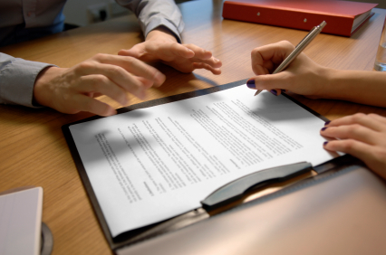 Negotiating and signing a Clipboard with Agreement Papers - Aber Law Firm